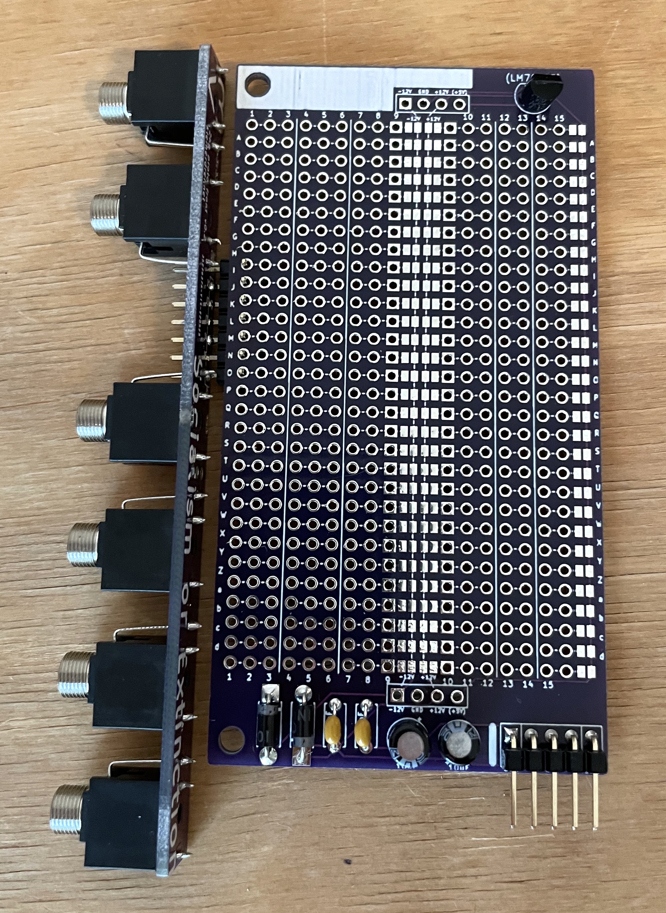 Photo of nucleus board with power supply components soldered in. It is connected to another PCB with sockets attached.